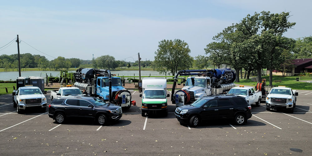 Merrillville Conservancy District vacuum trucks and service vehicles parked in a municipal lot