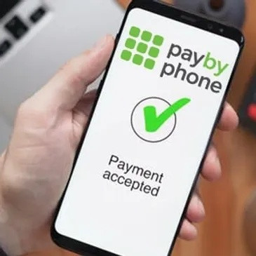 Smartphone screen displaying “Pay by phone” with a checkmark indicating payment accepted.